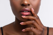 © Viacheslav Yakobchuk - African-American woman touching lips with shiny lip gloss