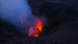 CLOSE UP: Bright orange pieces of magma are blasted out of an active volcano.