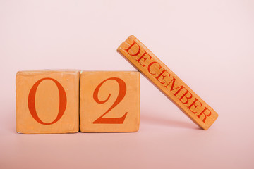 december 2nd. Day 2 of month, handmade wood calendar  on modern color background. winter month, day of the year concept