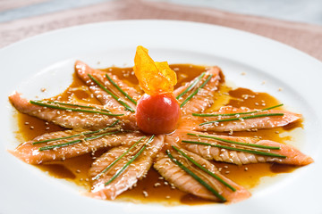 Carpaccio of salmon in tomato sauce.