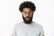© Cookie Studio - Close-up shot of attractive friendly-looking african american bearded man in glasses with pierced nose and afro hairstyle smiling joyfully at camera feeling positive, standing against gray background