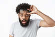 © Cookie Studio - Omg unbelievable. Portrait of impressed and surprised handsome adult african american bearded guy taking off glasses cannot believe own eyes dropping jaw and bending towards camera amazed