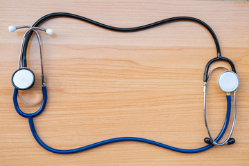 stethoscope on wooden texture background