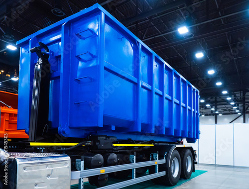 Dumpster on the car. Garbage removal. Dump semitrailer. Trailed equipment. Trucks. Special machinery.  Dump truck transportation of bulk cargo. Freight transport industry.