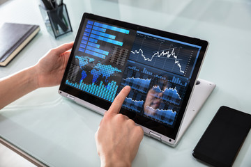 Businesswoman Analyzing Graph On Laptop