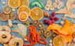 © lithiumphoto - Dried fruit and vegetable chips, candied pumpkin slices, nuts and seeds on blue wooden background