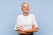 © luismolinero - Teenager girl with white short hair over blue wall smiling