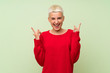© luismolinero - Teenager girl with white short hair over green wall making rock gesture