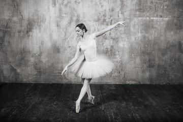 Wall Mural - Ballerina in ballroom. Ballet dancer in studio. Black and white monochrome.