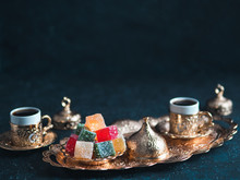 Turkish Coffee With Delight And Traditional Copper Serving Set On Dark Background. Assorted Traditional Turkish Dilight Or Lokum And Turkish Coffee In Metal Traditional Cups.Copy Space.Selective Focus