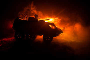 War Concept. Military silhouettes fighting scene on war fog sky background, World War German Tanks Silhouettes Below Cloudy Skyline At night. Attack scene. Armored vehicles. Tanks battle