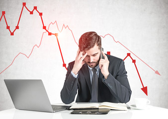 Concerned businessman and falling graph