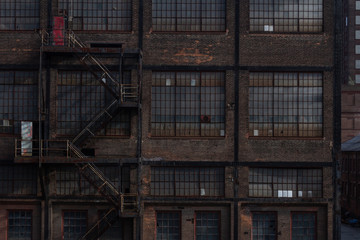 Wall Mural - Brick exterior of an industrial building with banks of windows and fire escape, horizontal aspect