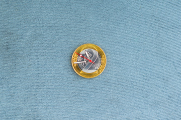 time and money, concept: second, hour and minute hands on a coin of 2 Belarusian rubles, on a light background, short focus