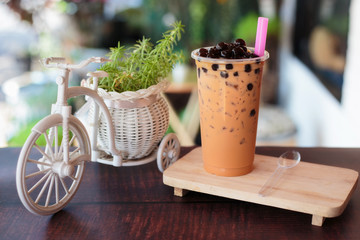 Ice bubble milk tea in takeaway glass.