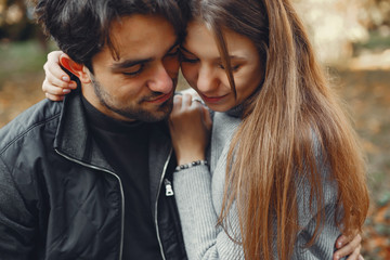 Cute couple in a spring city. Lady with long hair. Man in a black jacket