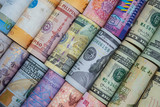Fototapeta  - Closeup rolled of variety banknote around the world. Exchange rate and Forex investment concept.-Image.