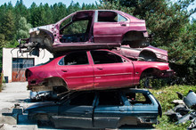 Old Crushed Cars Bodies Stored In Auto Wrecking Junk Yard For Scrap And Spare Parts