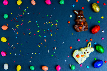 Wall Mural - Easter greeting card with colorful candy frame and Easter egg, chocolate bunny and eggs.