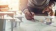 © Chaosamran_Studio - architect design working drawing sketch plans blueprints and making architectural construction model in architect studio
