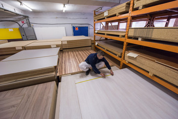 carpenter measuring wooden board