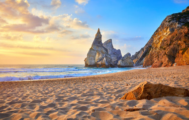portugal ursa beach at atlantic coast of atlantic ocean with rocks and sunset sun waves and foam at 