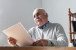 © sergign - Senior man reading a paper document or letter