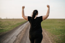 Body Positive, Freedom, High Self Esteem, Confidence, Happiness, Inspiration, Success, Positive Affirmation. Overweight Woman Celebrating Rising Hands To The Sky On Summer Meadow.