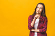 © denis_vermenko - Portrait of a pretty smiling woman in casual and glasses posing isolated on a yellow background.