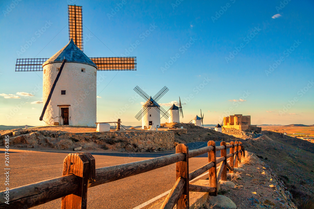 Spanish windmills and medieval castle on a hill in Consuegra, Toledo, Spain. - obrazy, fototapety, plakaty 