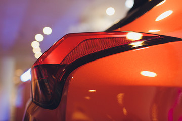 Detail on the rear light of a gold car.