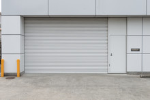 A Closeup Shot Of Automatic Metal Roller Door Used In Factory, Storage, Garage, And Industrial Warehouse. The Corrugated And Foldable Metal Sheet Offer Space Saving And Provide Urban And Rustic Feel