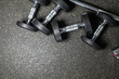 © Semachkovsky  - Many dumbbells lie randomly on the floor. Loft gym. Place for the text. Black wall.