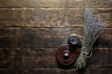 Dried lavender flower branch on a wooden table background with copy space. Herbal medicine concept.