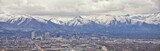 Fototapeta Natura - Downtown Salt Lake City Panoramic view of Wasatch Front Rocky Mountains from airplane in early spring winter with melting snow and cloudscape. Utah, USA.