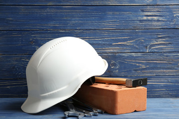 Composition with construction tools on table against wooden background