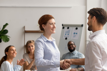 Wall Mural - happy female employee intern handshake helpful boss get rewarded promoted