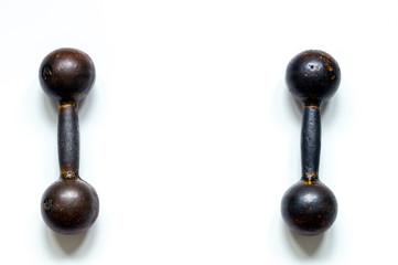 two metal old dumbbells on white background top view