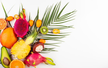 Canvas Print - Still life with fresh assorted exotic fruits on a palm leaf.