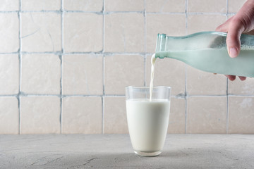 Wall Mural - Pouring milk into a glass