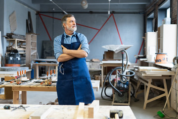 Wall Mural - Mature handsome joiner work in carpentry. He is successful entrepreneur at his workplace.