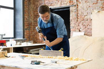 Wall Mural - Mature handsome joiner work in carpentry. He is successful entrepreneur at his workplace.