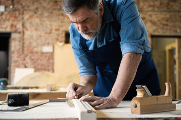 Wall Mural - Mature handsome joiner work in carpentry. He is successful entrepreneur at his workplace.