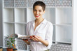© Alexander - young beautiful brunette woman sit at table in office read journal