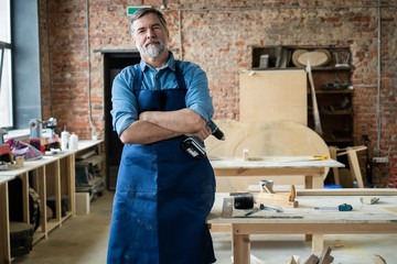 Wall Mural - Mature handsome joiner work in carpentry. He is successful entrepreneur at his workplace.