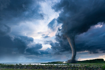tornado or twister storm clouds going over landscape and a ranch farm house destroying everything on