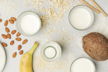 Assortment of organic vegan non-dairy plant-based milk in glasses, top view