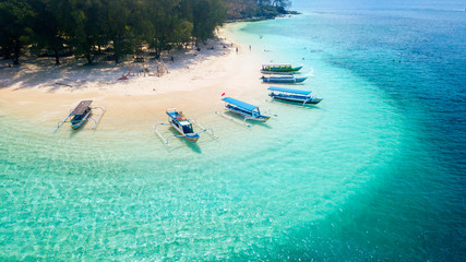 wooden boats anchored on the gili rengit beach