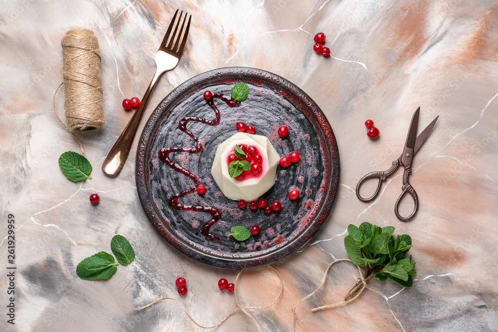 Plate with tasty panna cotta on color background