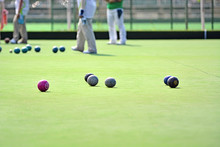Ladies Playing Lawn Bowls. Soft Focus On The Green Blurred Background